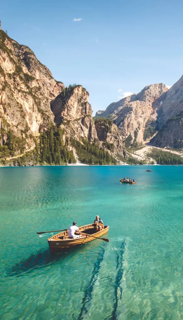 A rowboat on a turquoise mountain lake